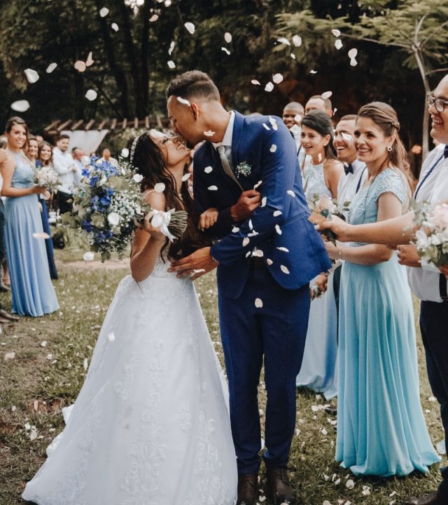 man in blue suit kissing woman in white wedding dress